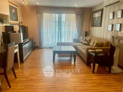 Spacious living room with modern decor and hardwood floors, perfect for relaxation and entertainment.