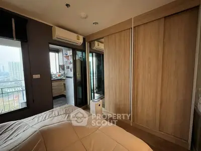 Cozy bedroom with wooden wardrobe and balcony view in modern apartment