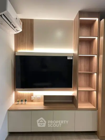 Modern living room with sleek TV unit and ambient lighting