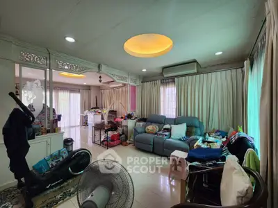 Spacious living room with cozy seating and ample natural light, ideal for family gatherings.