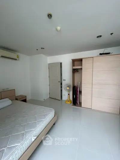 Spacious bedroom with modern wardrobe and air conditioning