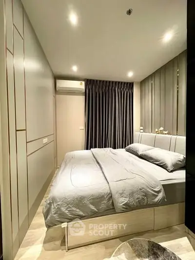 Modern bedroom with sleek design and cozy ambiance in a stylish apartment.