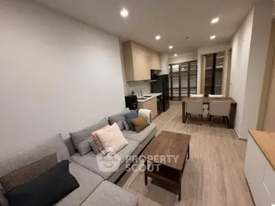 Modern open-plan living room with cozy seating and dining area