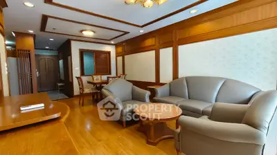 Elegant living room with classic wooden paneling and cozy seating area