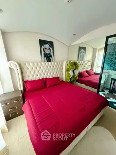 Luxurious bedroom with plush red bedding and elegant decor