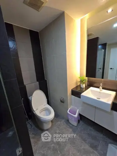 Modern bathroom with sleek design, featuring a stylish sink and toilet, perfect for contemporary living.
