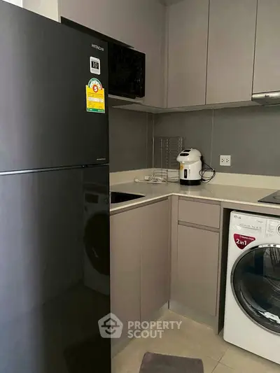 Modern kitchen with sleek appliances and compact design