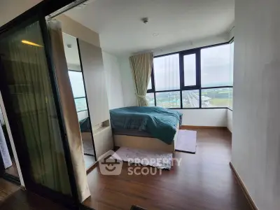Modern bedroom with panoramic city view and sleek wooden flooring