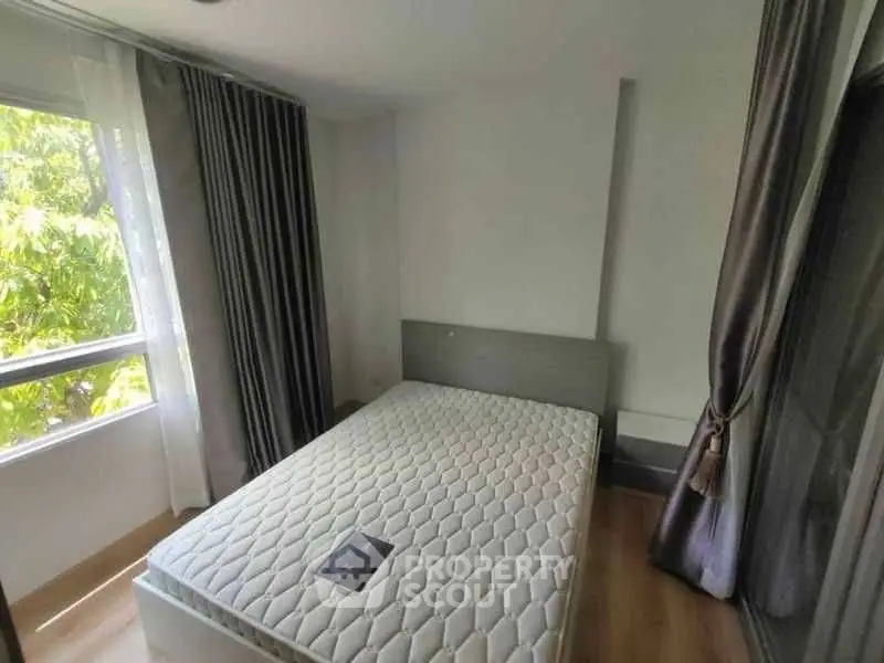 Cozy bedroom with large window and modern decor