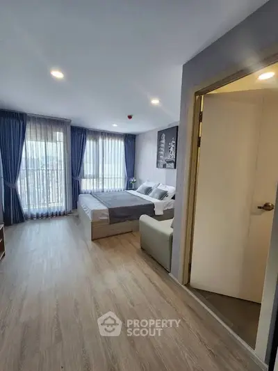 Spacious modern bedroom with large windows and elegant decor