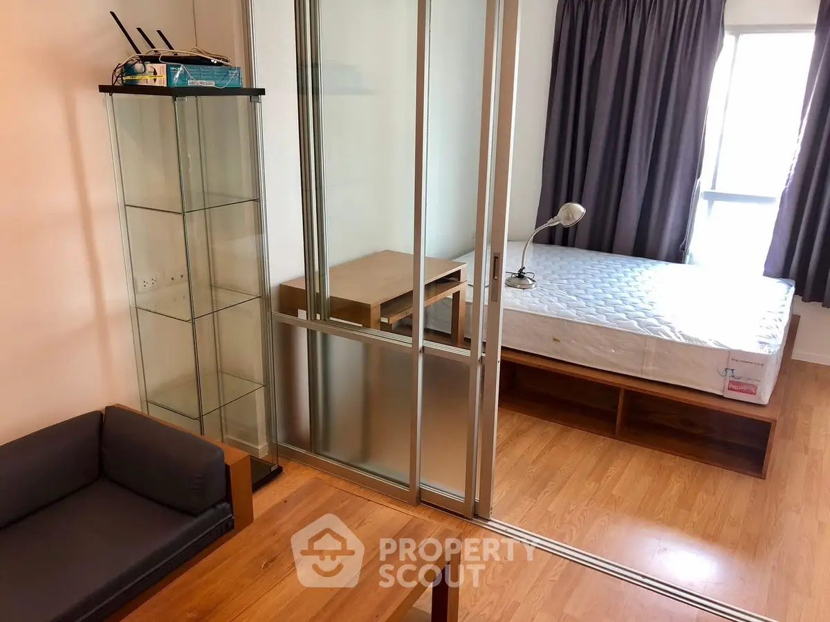 Modern studio apartment with glass partition and wooden flooring