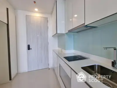 Modern kitchen with sleek cabinets and induction cooktop in minimalist design