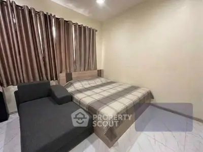 Cozy bedroom with modern decor and comfortable furnishings in a stylish apartment.