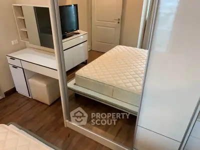 Modern bedroom with mirrored wardrobe and sleek furniture design