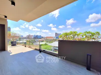 Spacious balcony with stunning city view and modern design, perfect for relaxation and entertainment.