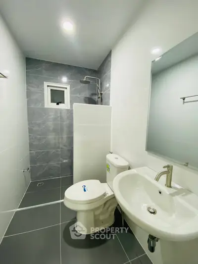 Modern bathroom with sleek gray tiles and contemporary fixtures