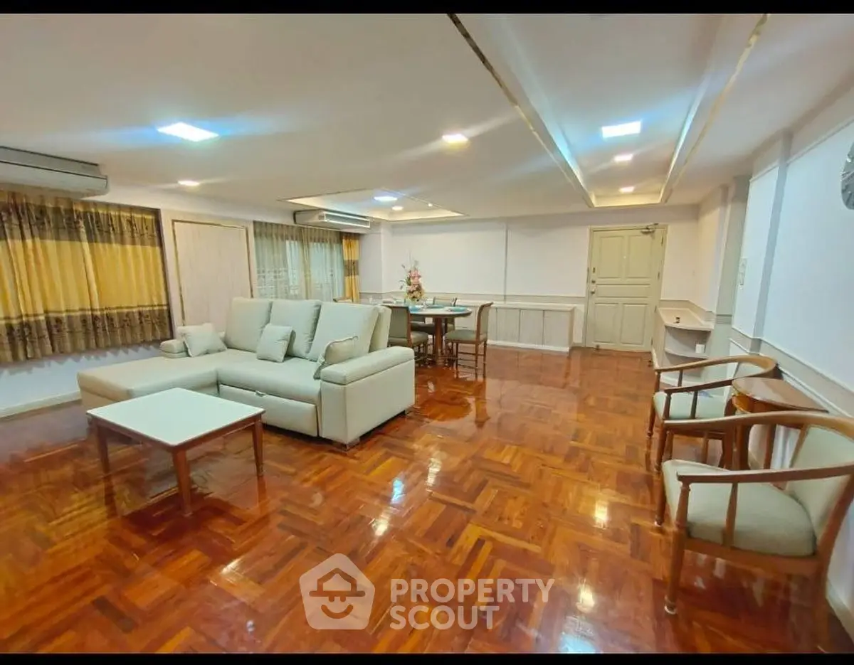 Spacious living room with elegant wooden flooring and modern furniture