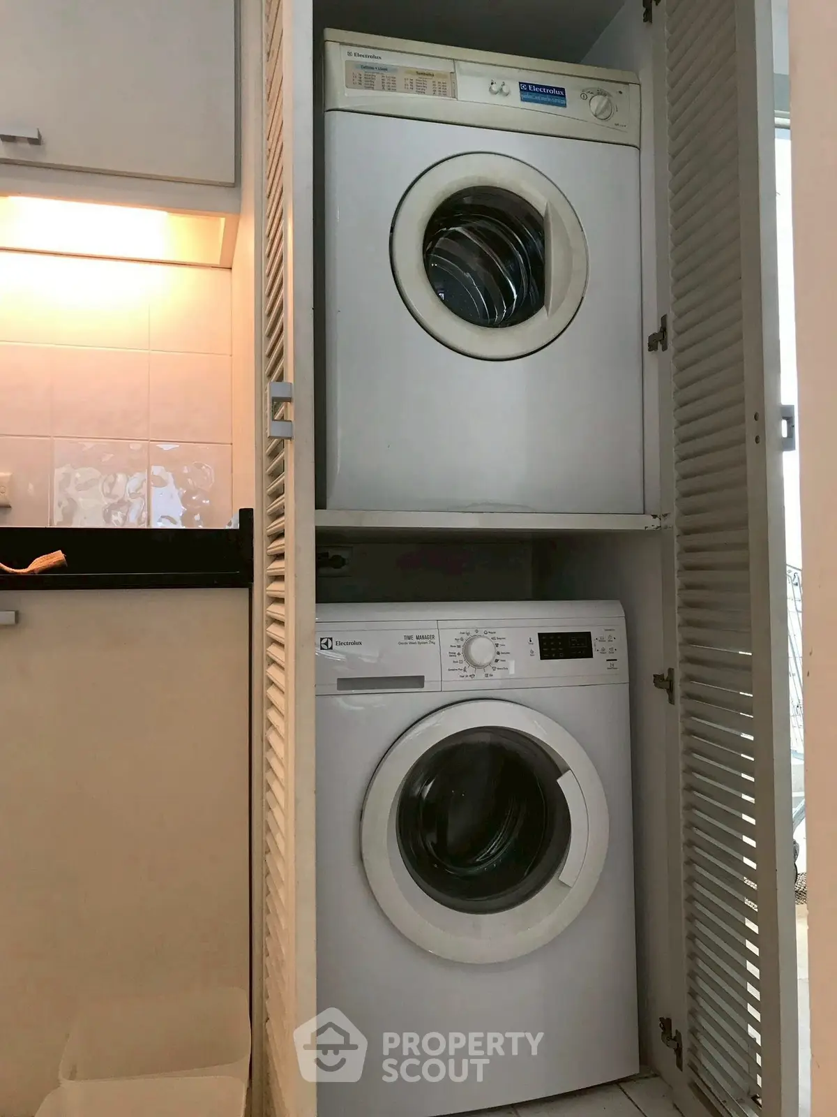 Compact laundry area with stacked washer and dryer in modern home