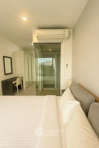 Modern bedroom with sleek design and balcony access