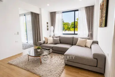 Spacious modern living room with large windows and stylish decor