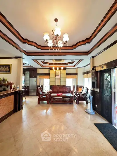 Luxurious living room with elegant chandelier and classic wooden furniture