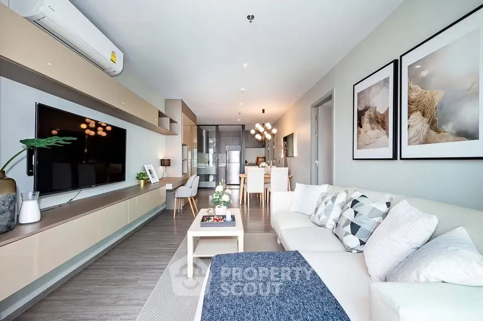 Modern living room with stylish decor and open layout, featuring a cozy seating area and elegant dining space.