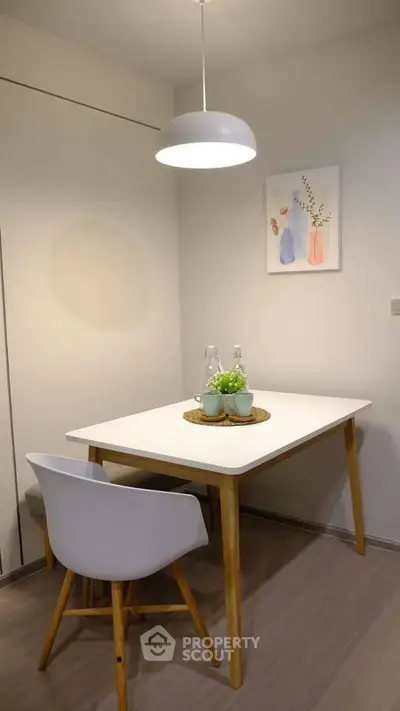 Cozy dining nook with modern decor and elegant lighting in a stylish apartment.