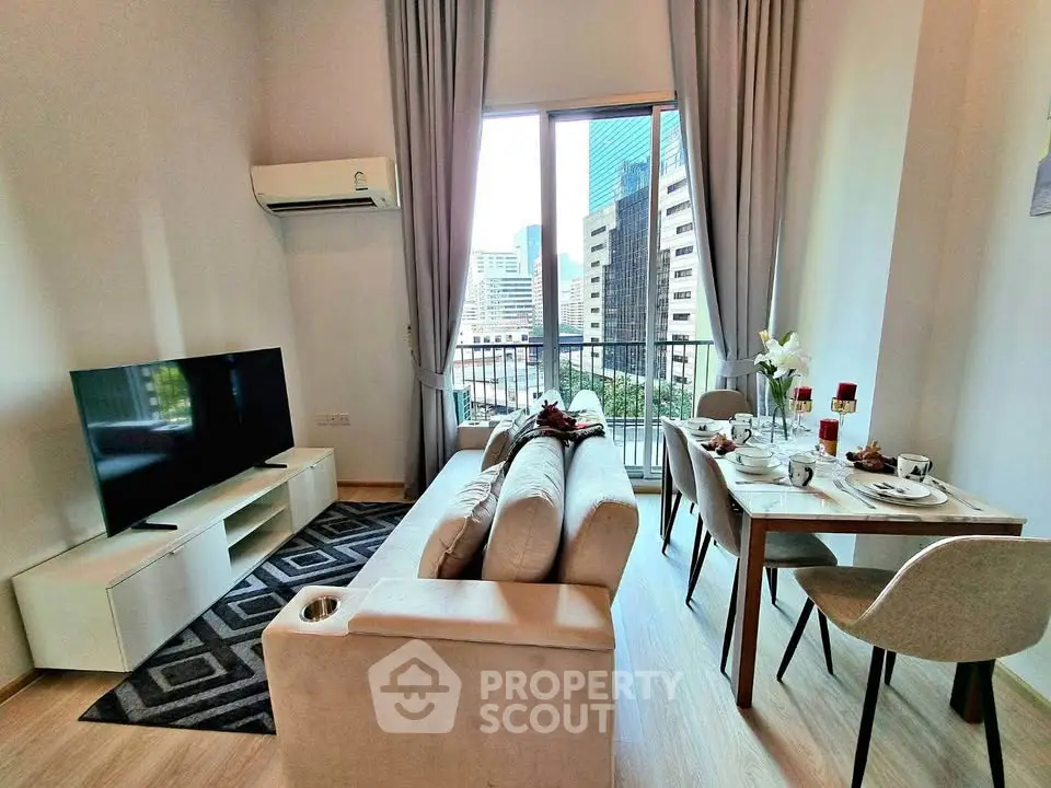 Modern living room with balcony view in urban apartment, featuring stylish furniture and dining area.