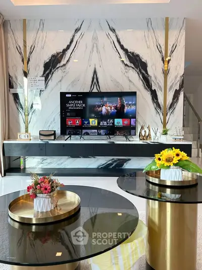 Luxurious living room with marble accent wall and modern decor