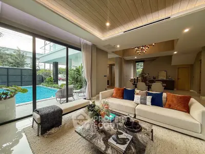 Luxurious living room with pool view, modern decor, and elegant furnishings