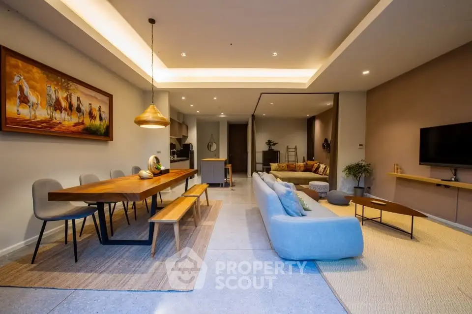 Spacious modern living room with open layout, stylish furniture, and elegant lighting.