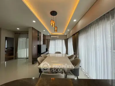 Luxurious modern dining room with elegant lighting and large windows