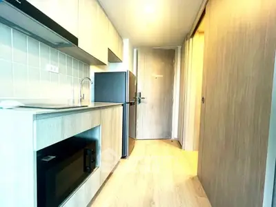 Modern kitchen with sleek cabinetry and built-in appliances in a compact layout.