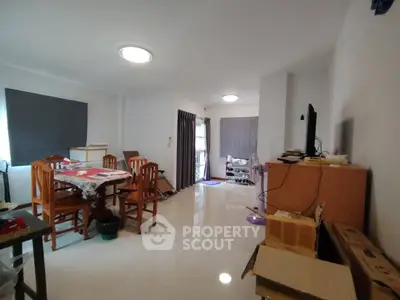 Spacious living room with dining area and modern decor in a bright apartment.