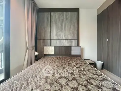 Modern bedroom with stylish wood paneling and large window for natural light.