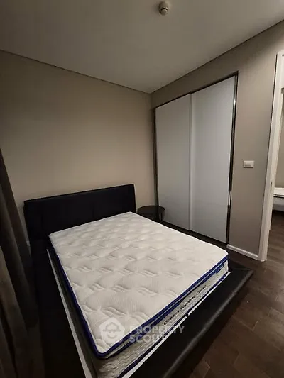 Modern bedroom with sleek design and comfortable mattress in stylish apartment.