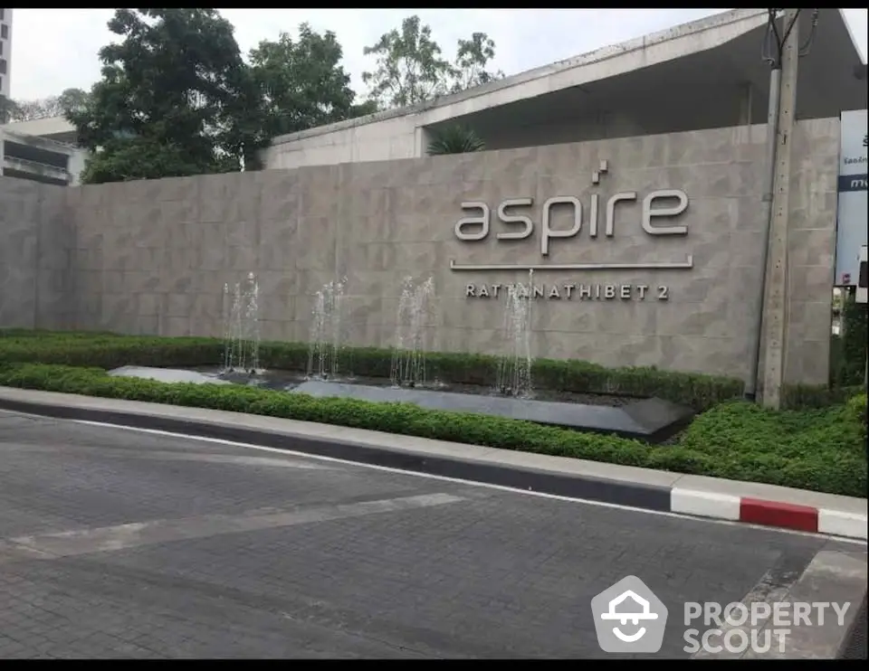 Modern entrance of Aspire Rattanathibet 2 with sleek design and water feature