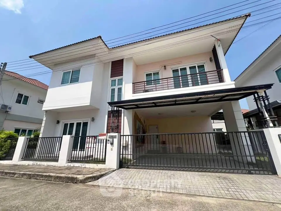Modern two-story house with spacious driveway and balcony in a suburban neighborhood.