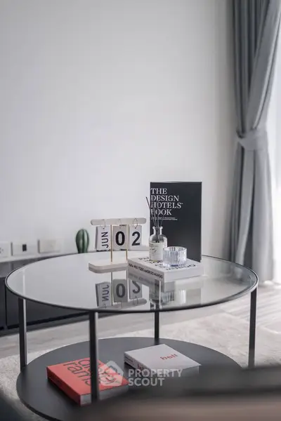 Stylish modern living room with glass coffee table and elegant decor