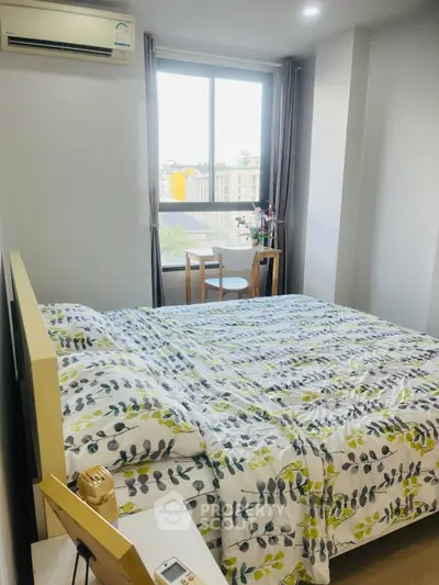 Cozy bedroom with large window and modern decor in city apartment