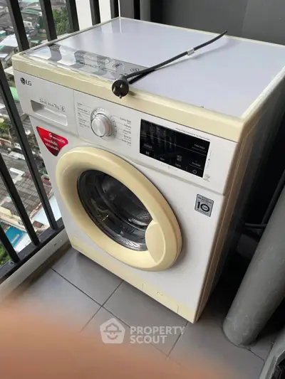 Modern washing machine on balcony with city view, perfect for urban living convenience.