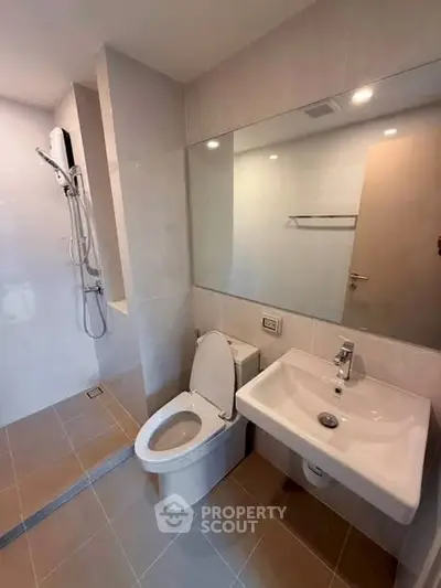 Modern bathroom with sleek fixtures and spacious shower area.
