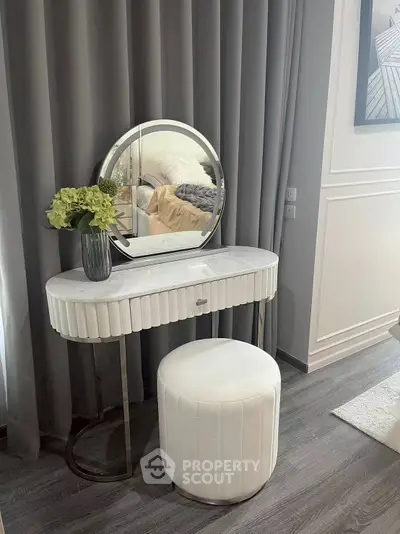 Elegant bedroom vanity setup with modern decor and plush seating