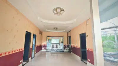 Spacious interior hallway with elegant ceiling lights and large windows