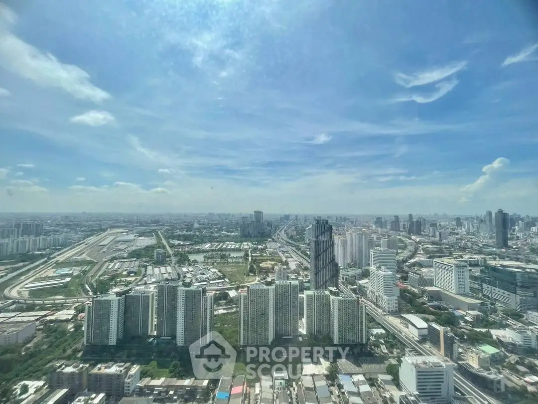 Stunning panoramic cityscape view from high-rise building, showcasing urban skyline under a clear blue sky.