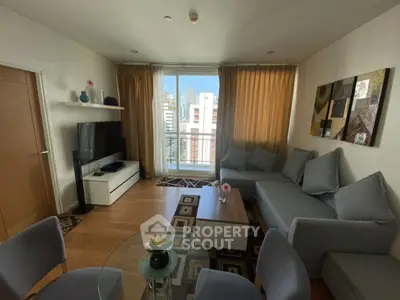 Modern living room with large sofa and city view balcony