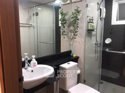 Modern bathroom with glass shower and sleek fixtures