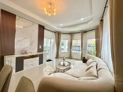 Luxurious living room with elegant decor and large windows offering natural light.