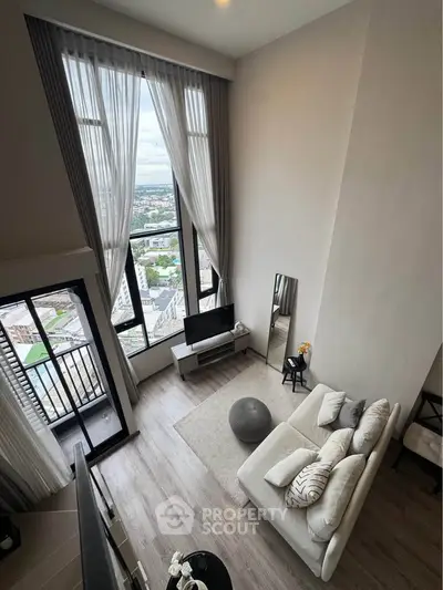 Stunning high-ceiling living room with panoramic city view and modern decor.