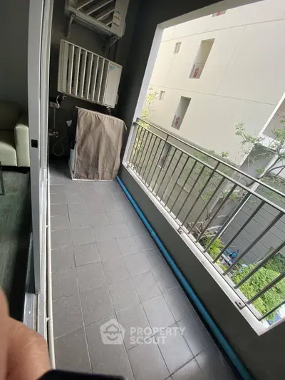 Spacious balcony with modern railing and outdoor air conditioning unit, perfect for relaxation.
